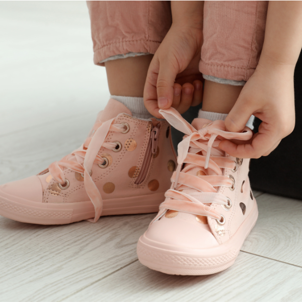 girl tying shoelace